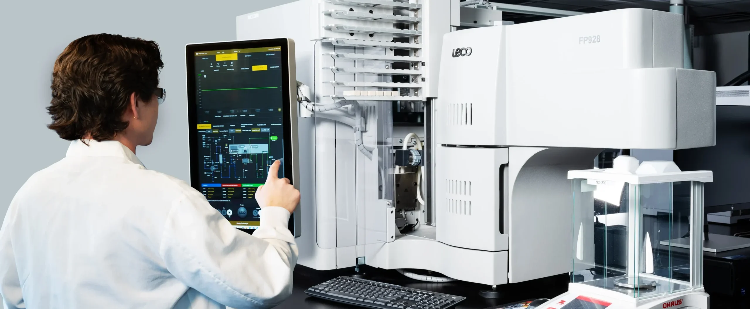 Laboratory scientist operating advanced analytical testing equipment with a digital control interface for active ingredient testing.