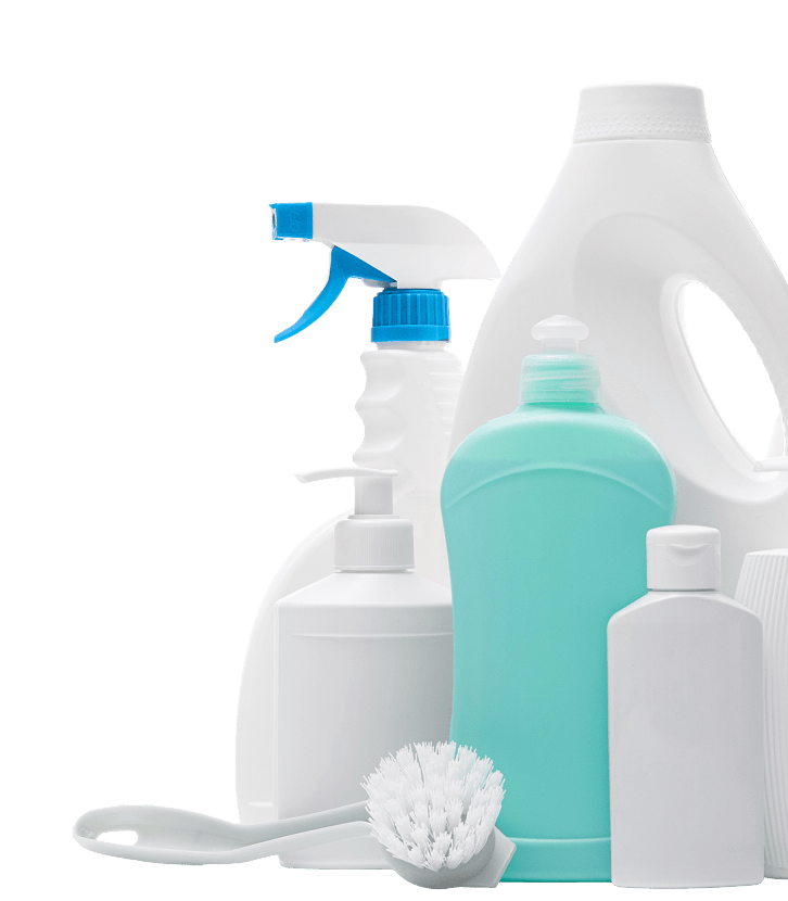 Assortment of household cleaning bottles, spray cleaner, soap dispensers, brushes, and sponge on a white background.